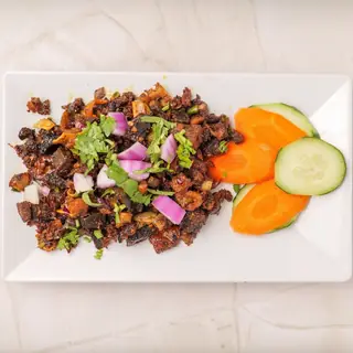 Nepali bhuttan — bold, spicy stir-fried tripe with onions, garlic and fresh green chilies, a traditional Newari appetizer