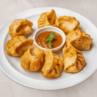 Golden crispy Nepali fried momo dumplings served with dipping chutney