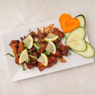 Nepali pork fry — caramelized tender pork pieces wok-fried with garlic, ginger, onions and fiery green chilies
