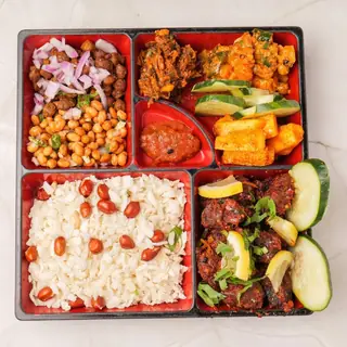 Traditional Newari samaibaji khaja set — beaten rice platter with roasted meat, spiced potatoes, black soybeans and achar