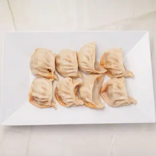 Plate of authentic Nepalese steamed momo dumplings served with tomato-sesame chutney at Laliguras Restaurant