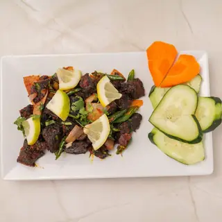 Nepali buff sukuti — smoky sun-dried meat jerky pan-fried with fresh tomatoes, onions and green chilies