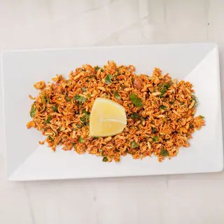 Wai Wai sadheko — crunchy instant noodles tossed with fresh onions, tomatoes, green chilies and lime, a popular Nepali street snack